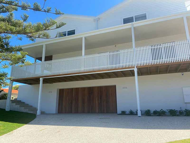 The freshly painted exterior of a white residential property